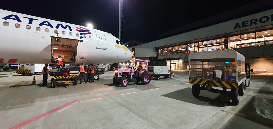 Foto de área externa de aeroporto com avião estacionado. 