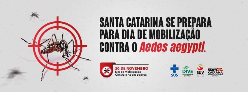 'Banner de campanha com fundo cinza claro e vários mosquitos voando. Um mosquito Aedes aegypti aparece ampliado no centro de uma mira vermelha. Ao lado, em letras maiúsculas pretas e vermelhas, está o texto: 'Santa Catarina se prepara para dia de mobilização contra o Aedes aegypti'. Abaixo, um bloco vermelho com o símbolo de um mosquito cortado por uma linha traz o aviso: '20 de novembro - Dia de Mobilização Contra o Aedes aegypti'. No rodapé direito estão os logotipos do SUS, DIVE, SUV e Governo de Santa Catarina - Secretaria de Estado da Saúde.